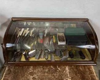 BIHY101 Antique Retail Display Case, Full	This is a wood framed display case with a large collection of branded shoe horns and antique boot hooks. The shoe horns vary in size and shape, and advertise various vintage shoe and clothing stores from around the area and across the country.
