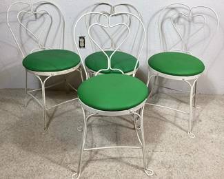 BIHY103 Four Vintage Ice Cream Chairs	This is a set of four matching&nbsp;ice cream chairs. The vintage chairs are made of bent and curved iron that has been painted white. The reupholstered seat cushions are made of a stain resistant fabric-like plastic cover that are still vibrantly green.
