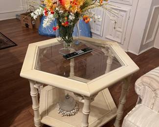 Octagonal side table with glass top, bamboo style legs and tightly woven wicker shelf.