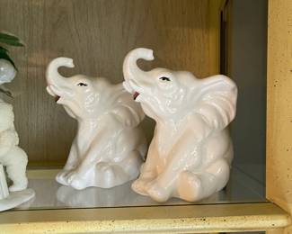 White ceramic seated elephants trumpeting