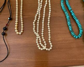 Many strands of elegant pearls with beautifully finished clasps in silver 