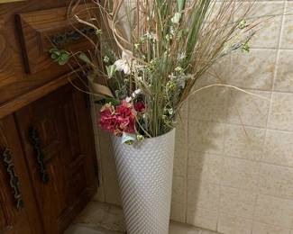 Tall artificial flower arrangements in pretty white tall vase