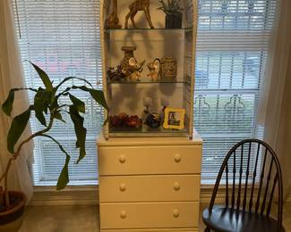 27" tall white cabinet with three drawers. Wicker arch with two shelves.