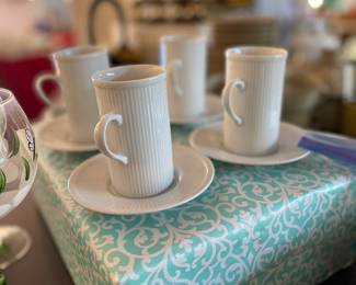 Elegant slender white ribbed coffee cups with saucers