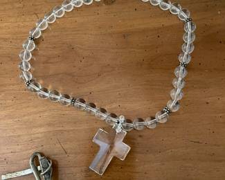 Clear and silver beaded cross necklace with a silver clasp.