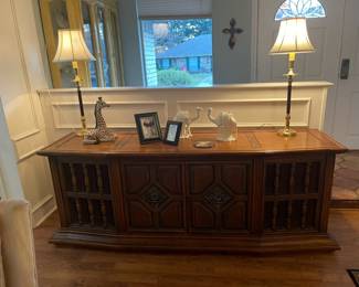 Circa 1960's phonograph and receiver cabinet. Turntable and radio along with collectable vinyl records. Statement piece and rare find! 