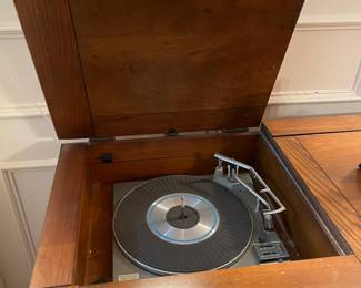 Circa 1960's phonograph and receiver cabinet. Turntable and radio along with collectable vinyl records. Statement piece and rare find! 