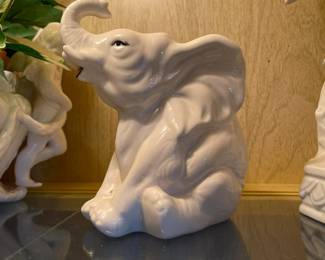 Seated trumpeting elephant figurine
