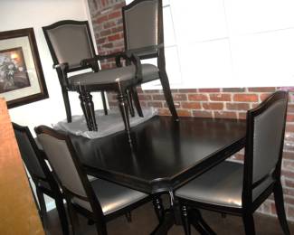 Beautiful brand new Contemporary dining suite includes a table with 6 side and 2 captain's chairs.  Chairs are padded in a soft gray leather.