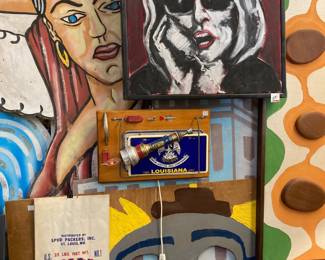 Top:  Painting by New Orleans artist Jason Dumouchel, underneath a lightup Louisiana piece by Jazz Fest favorite, Jimmy Descant; misc. potato sack and clown toss game.  To the right, a Witco-inspired piece by Mike Hoff