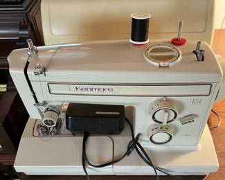 This sewing machine and traveling case were made by Kenmore.  