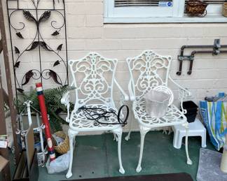 A pair of wrought iron patio chairs are the central focus of this sale, along with the Welcome patio art and the traffic "cone".