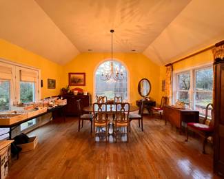 Breakfast Room | A large selection of kitchen tools, vintage and antique furnishings, and a farmhouse chic table with mismatched chair sets.