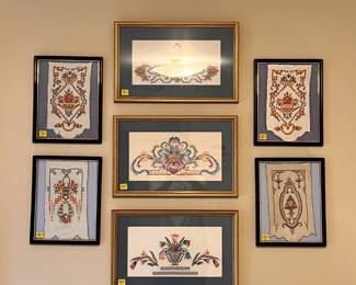 Bedroom 2 | Closer view of the framed antique hand-done cross-stitch fragments.