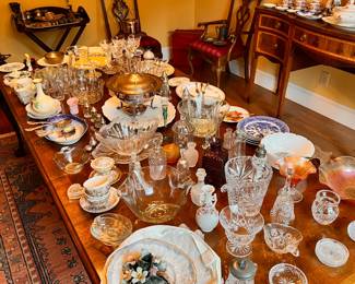 Dining Room | A huge selection of antique and vintage tableware, serveware, and barware is displayed on the beautiful Chippendale dining table.