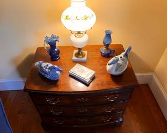 Living Room | Atop this stately dresser is a playful pair of blue and white pottery ducks, a beautiful mother-of-pearl-covered bible, and yet another antique hand-painted electrified Victorian oil lamp.