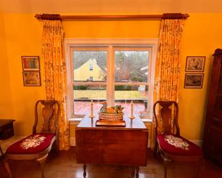 Breakfast Room | A beautiful antique French pine turned-leg drop-leaf table is flanked by a pair of early 20th-century Queen Anne-style mahogany chairs with hand needle-pointed upholstery.