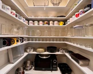Kitchen | A pantry full of helpful kitchen wares, floral containers, and dozens of coffee mugs collected from all over the state of Georgia.