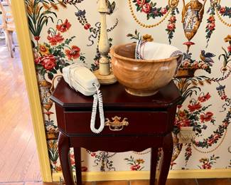 Kitchen | The vintage Queen Anne style phone table with assorted wooden decor.