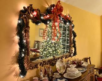 Dining Room | Lit garlands hang on a beautifully gilded English Chinoiserie replica mirror above the large Hepplewhite inlaid and banded sideboard c1915.