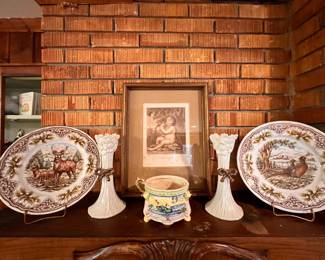 Family Room | Fine woodland-themed dinnerware, a pair of floral porcelain candlesticks, and a lovely colorful jardiniere all frame a beautiful antique framed print.