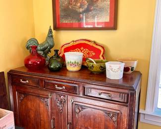 Breakfast Room | Antique Art Deco c1920-25 buffet cabinet with charming carved details, a large green pottery rooster, art glass, and miscellaneous bowls and pots.
