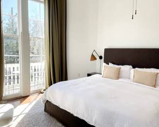 upholstered bed, drapes, rods, wicker sconces