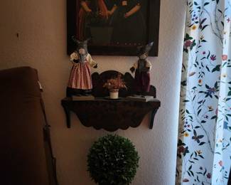 Small shelf, several topiary trees in various sizes, many pictures and wall art in various sizes