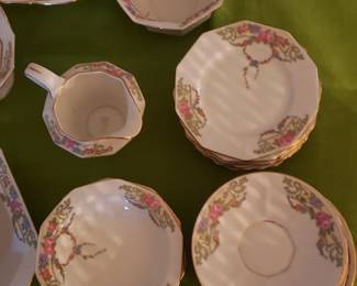Large fine china set. Several sizes of plates, salad bowls, serving pieces as well. Floral pattern on edges.