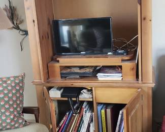 Doors open on pine cabinet. Upper doors slide back into unit.