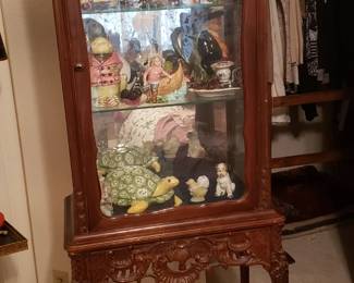 Selling several curio cabinets. This one with curved legs is unusual.