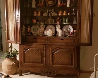 Unusual cabinet that is actually a bar. Drawer in middle pulls out. Upper shelves for glassware. Lower cabinet for bottles. Or use as display cabinet as I have. Items in cabinet also for sale.