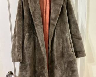 Taupe Faux fur cocoon coat with satin lining and a shawl collar.