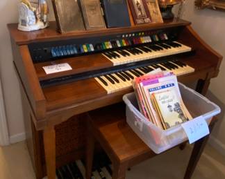Electric organ, sheet music and vintage hymnals