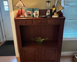 Living Room - quality Bob Timberlake wood cabinet with decorative accessories.  Sailboat, hourglass and lamp