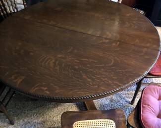 Round Dining Table with a carved rope accent of strength along the edge creates a stunning look and a delightful feel with the smooth glossy finish