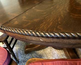 Round Dining Table with a carved rope accent of strength along the edge creates a stunning look and a delightful feel with the smooth glossy finish