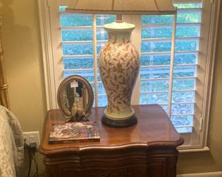 One of two fruitwood Provincial nightstands;  one of two matching lamps