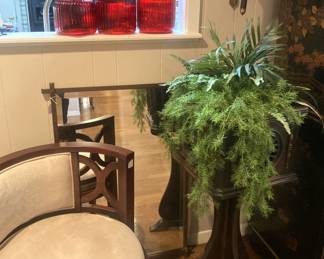 Round seat chair; mirror; plant; plant stand