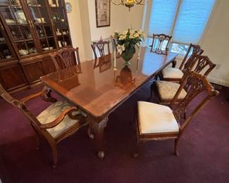 Beautiful dining table with leaves, table top protector, 8 chairs, and built in silverware holder