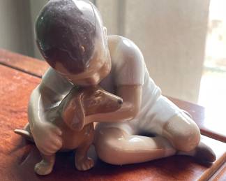 Royal Copenhagen "Boy Hugging Dog" Figurine.