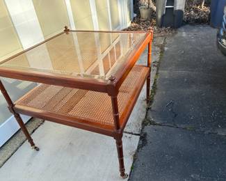 Baker two tier side table with cane detailing on rollers; $400