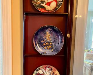 Avon porcelain plates trimmed in 22k gold, in a wall hanging case with glass door.