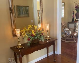 Cherry entrance table, pair of lamps , large framed mirror, flower arrangement