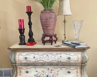Bombay painted chest, candles, pottery vase, small brass lamp.