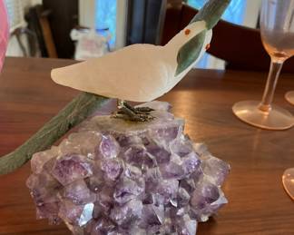 Carved stone bird on amethyst