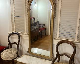Victorian walnut carved chairs, marble top table, and fancy mirror. 