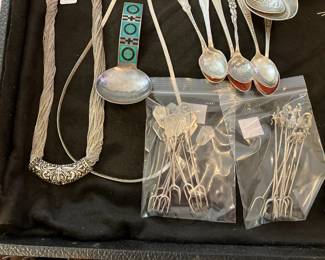 Lots of hor d'oeuvre forks in sterling