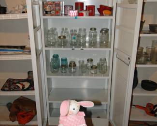Very nice and sturdy vintage metal double door cabinet and a very nice variety of canning jars