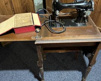 Vintage REVERSEW Electric Sewing Machine with Original Manual. Comes compete with wooden sewing table and some accessories.  